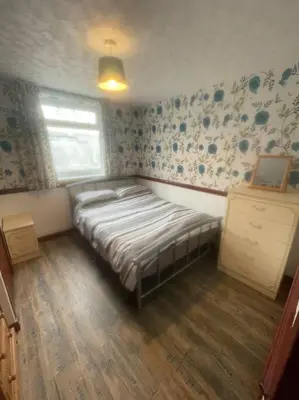 a bedroom with a bed in the corner of a room at Lovely flat in heart Blackpool in Blackpool