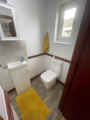 a bathroom with a toilet and a sink and a window at Lovely flat in heart Blackpool in Blackpool