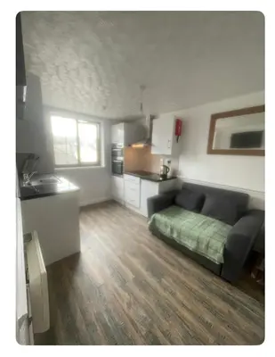a living room with a couch and a kitchen at Lovely flat in heart Blackpool in Blackpool