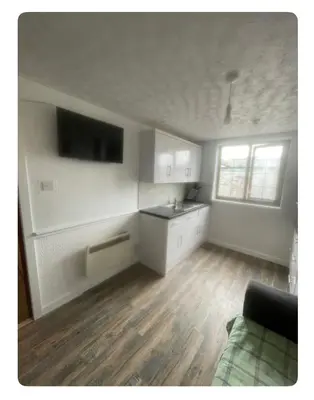 a room with a kitchen with a sink and a table at Lovely flat in heart Blackpool in Blackpool