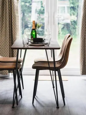a table with a bottle of wine and two chairs at Comfy Spacious Home Near Preston City Centre - Sleeps 6 in Samlesbury
