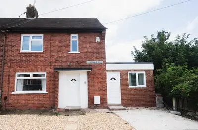 a red brick house with a white door at Comfy Spacious Home Near Preston City Centre - Sleeps 6 in Samlesbury