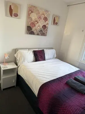 a bedroom with a bed and a painting on the wall at The Hotel And Bar Blackpool in Blackpool