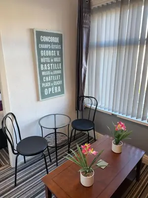 a table and chairs in a waiting room at The Hotel And Bar Blackpool in Blackpool