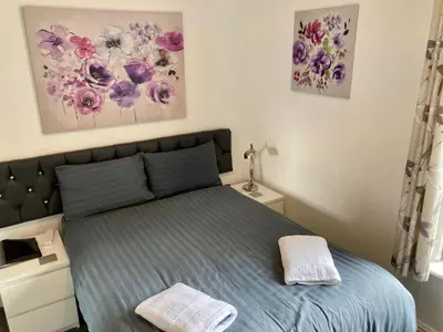 a bedroom with a bed and two paintings on the wall at The Hotel And Bar Blackpool in Blackpool