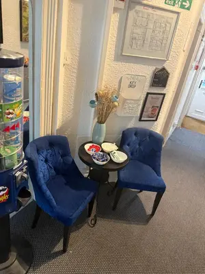 two blue chairs and a table in a room at The Hotel And Bar Blackpool in Blackpool