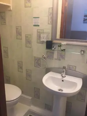 a bathroom with a sink and a toilet at Kirkstall Guest House in Blackpool