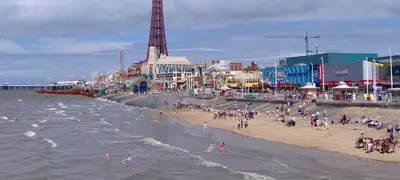 a group of people on a beach near the ocean at Kirkstall Guest House in Blackpool