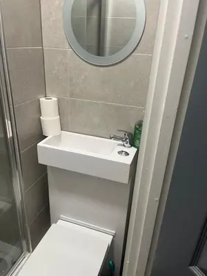 a bathroom with a sink and a mirror at Townsend lane accommodation in Liverpool