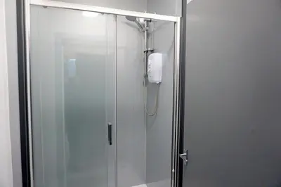 a shower in a bathroom with a glass door at Townsend lane accommodation in Liverpool