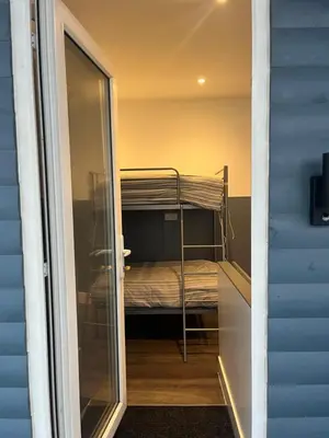 a door leading to a room with a bunk bed at Townsend lane accommodation in Liverpool