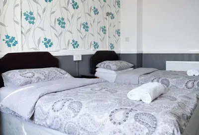 two beds sitting next to each other in a bedroom at The Gurkha Hotel in Blackpool