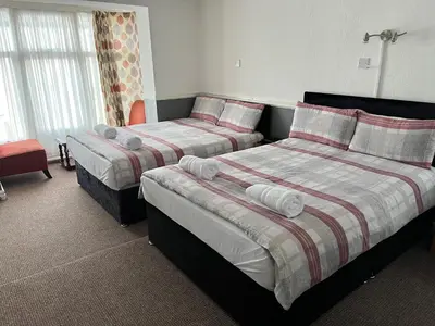 two beds in a hotel room with two bedsskirts at The Gurkha Hotel in Blackpool