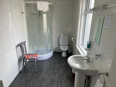 a bathroom with a shower and a toilet and a sink at The Gurkha Hotel in Blackpool
