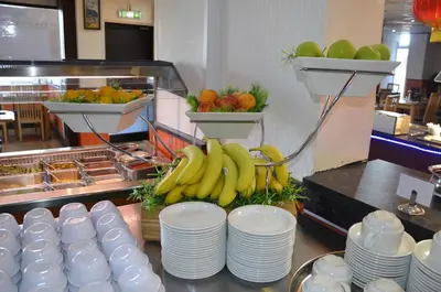 a buffet with plates and bananas and fruit on a counter at The Gurkha Hotel in Blackpool