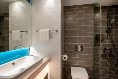 a bathroom with a tub and a sink and a shower at Holiday Inn Express Liverpool - Central by IHG in Liverpool
