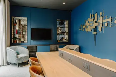 a dining room with blue walls and a table and chairs at The Halyard Liverpool, Vignette Collection by IHG in Liverpool