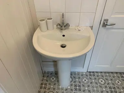 a white sink in a bathroom with a door at Waterloo Sunset in Blackpool
