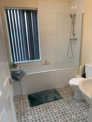 a bathroom with a tub and a toilet and a sink at Waterloo Sunset in Blackpool