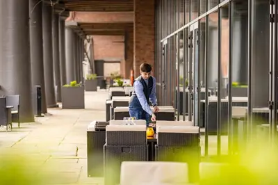 a man standing in front of a bunch of suitcases at Titanic Hotel Liverpool in Liverpool