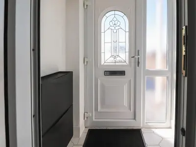 a white door with a window in a room at 26 North Promenade in Cleveleys