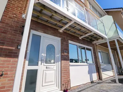a front door of a brick building with a garage at 26 North Promenade in Cleveleys