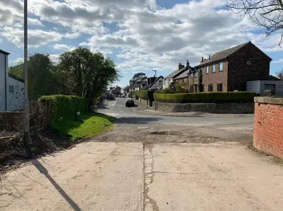an empty street in a small town with houses at Newton Hall Farm cottage, hot tub garden views Nr Lytham Ribby in Preston