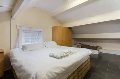 a bedroom with a large white bed with two towels on it at Brecks Hotel in Blackpool