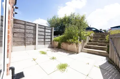 a patio with stairs and plants in front of a building at Contemporary 3 Bedroom Home with Garden & Parking in Atherton