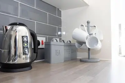 a kitchen with a coffee maker and a mixer at Contemporary 3 Bedroom Home with Garden & Parking in Atherton