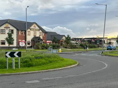 a winding road in a town with houses at Buckshaw Snoozy in Heapey