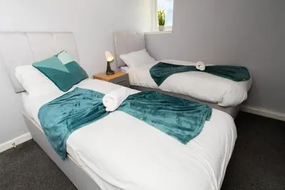 a room with two twin beds withskirts at Bloomfield Apartments in Blackpool