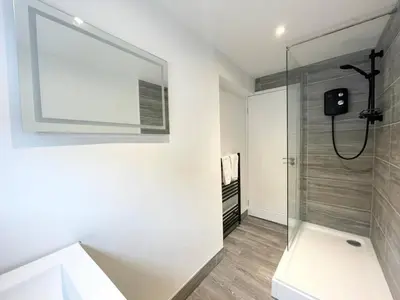 a bathroom with a shower and a glass shower stall at Bloomfield Apartments in Blackpool