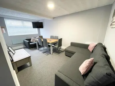 a living room with a couch and a table at Bloomfield Apartments in Blackpool