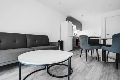 a living room with a couch and a table and chairs at GuestReady - A lovely hideaway in Vauxhall in Liverpool
