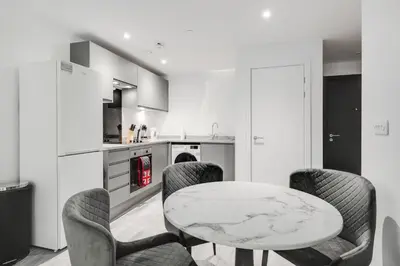 a kitchen with a marble table and chairs at GuestReady - A lovely hideaway in Vauxhall in Liverpool