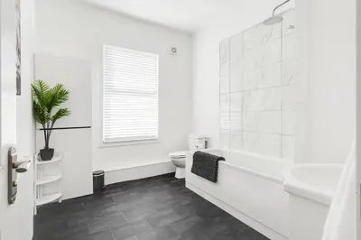 a white bathroom with a toilet and a sink at DACY LODGE, Anfield - Strictly NO Parties in Liverpool