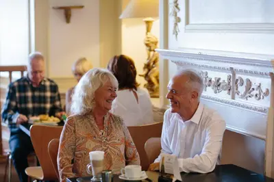 an older man and woman sitting at a table at Claremont Hotel - All Inclusive! in Blackpool