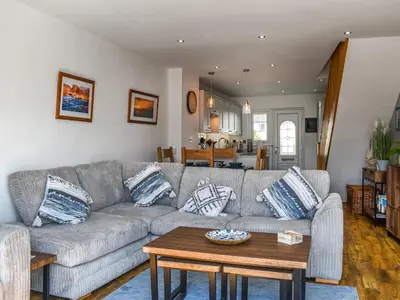 a living room with a couch and a table at Kingfishers Rest in Millom