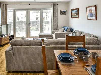 a living room with a couch and a table at Kingfishers Rest in Millom