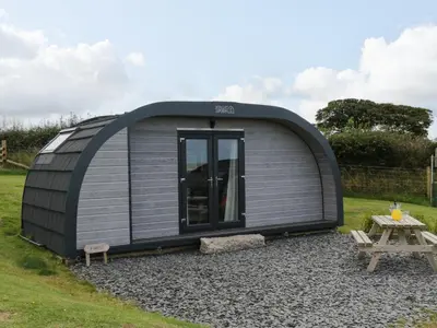 a grey and black shed with a picnic table at Forest in Dalton in Furness