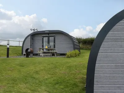 a circular shed with a picnic table in a field at Forest in Dalton in Furness