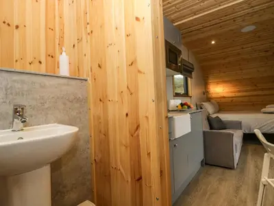 a bathroom with a sink and a bed in a room at Forest in Dalton in Furness