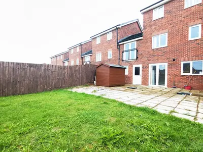 a brick house with a fence and a yard at Guest Rooms Near City Centre & Anfield Free Parki in Liverpool