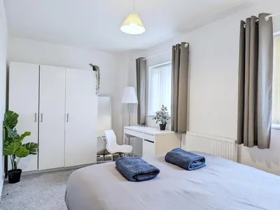 a bedroom with a bed with two pillows on it at Guest Rooms Near City Centre & Anfield Free Parki in Liverpool