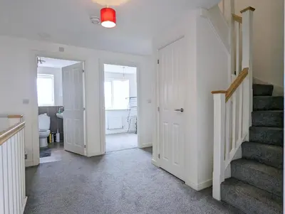 a hallway with a staircase and a white door at Guest Rooms Near City Centre & Anfield Free Parki in Liverpool