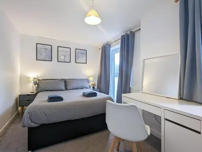 a bedroom with a bed and a desk and a chair at Guest Rooms Near City Centre & Anfield Free Parki in Liverpool