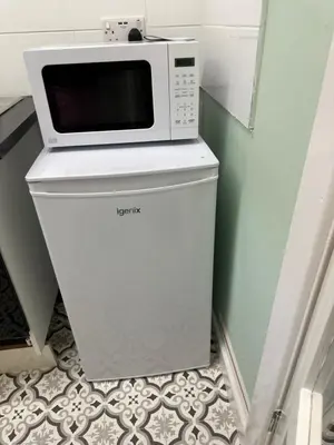 a microwave sitting on top of a refrigerator at The Big One Blackpool in Blackpool