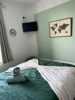 a bedroom with a bed with a blanket on it at The Big One Blackpool in Blackpool