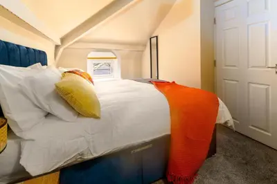 a bedroom with a large white bed with pillows at Clock Tower Retreat - Sea View Apartments in Morecambe in Morecambe